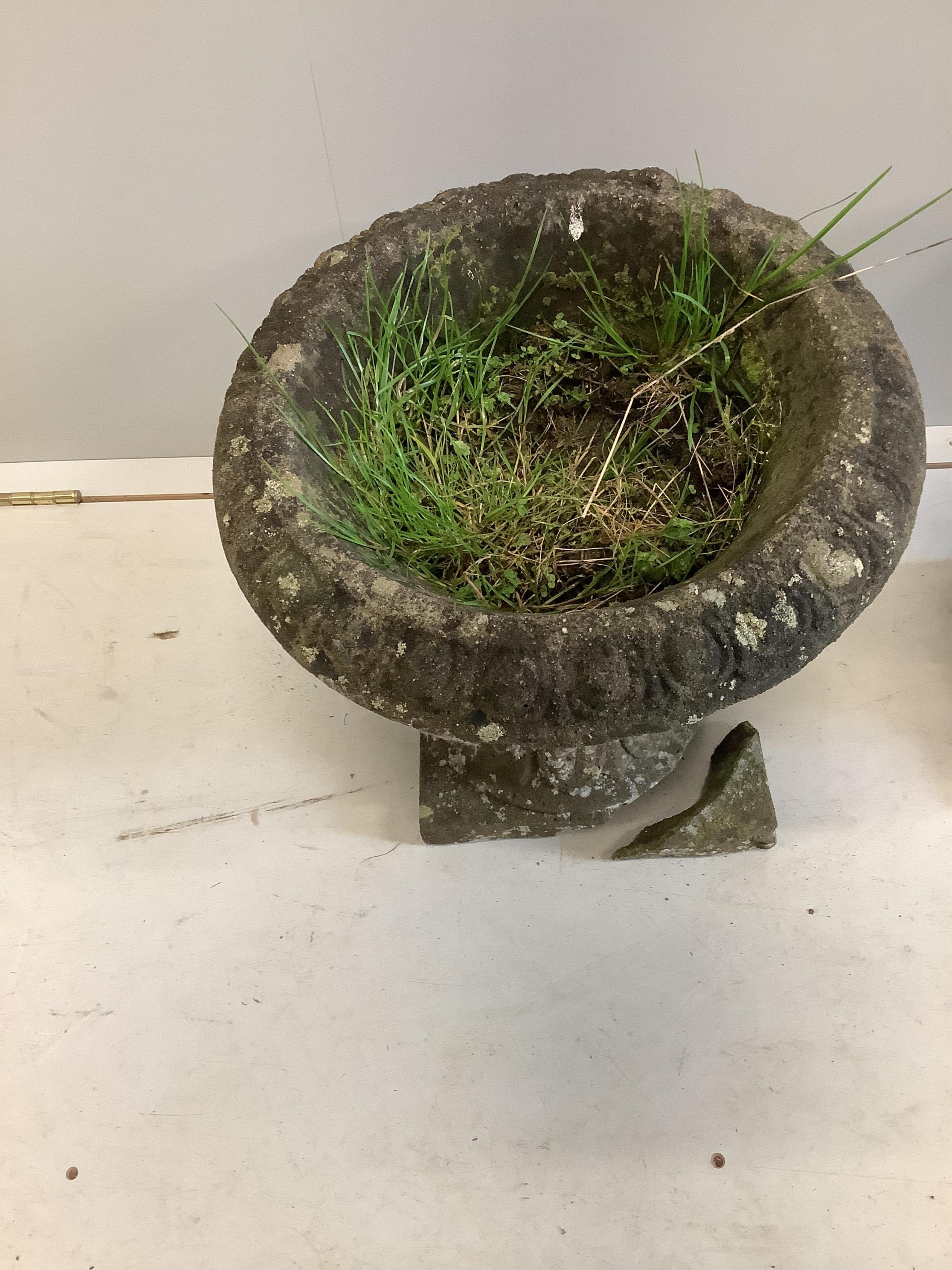 A pair of reconstituted stone circular campana garden urns, diameter 40cm, height 38cm. Condition - poor to fair